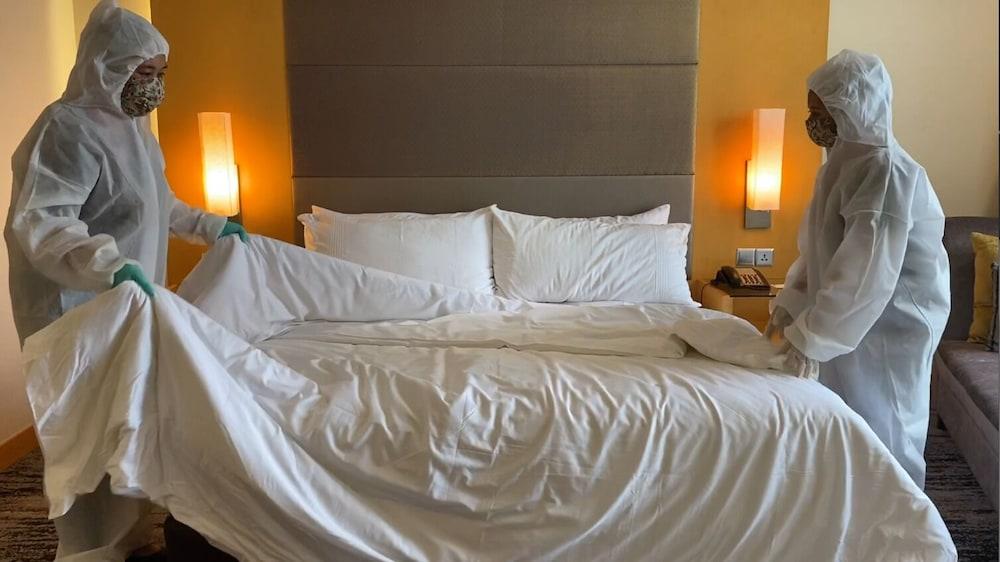The Waterfront Hotel Kuching Eksteriør bilde Housekeeping staff making a bed