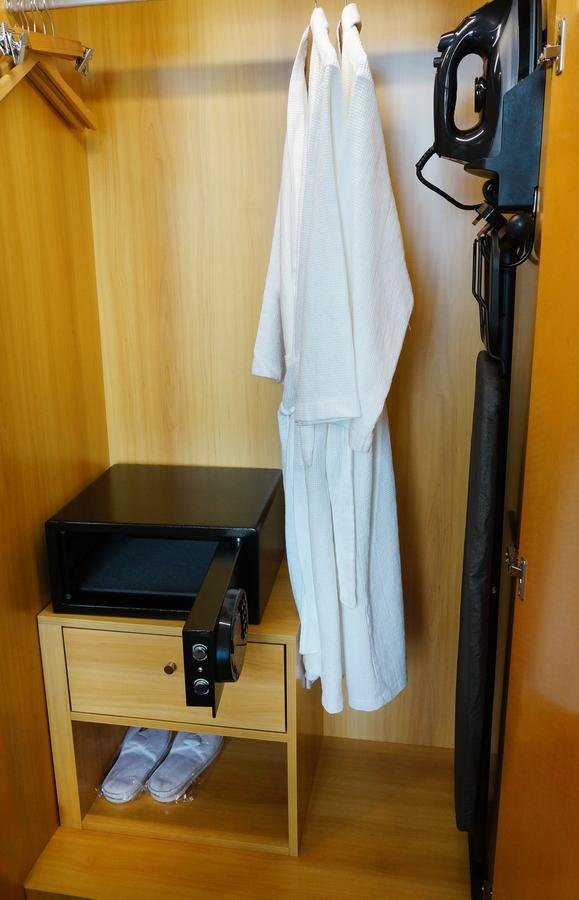 The Waterfront Hotel Kuching Eksteriør bilde A bathrobe hanging in a closet